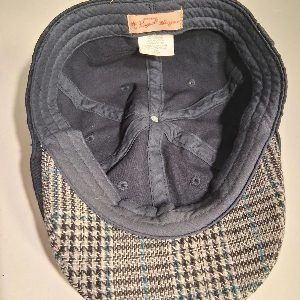 Mens Navy blue flat cap with white penguin logo plaid detail under brim